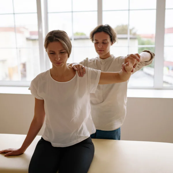 A therapist giving thai stretching therapy to a women